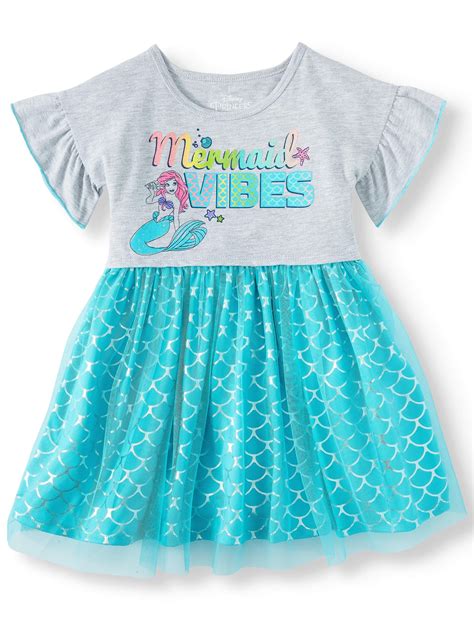 This blue, green, and violet ombre dress features a scalloped, fish-scale design and a layered mesh fishtail hem for a magical mermaid look. Shoulder straps comfortably support the dress, and the skirt allows plenty of room to run and play. Kids' The Little Mermaid Ariel Costume product details: Little Mermaid dress 100% polyester