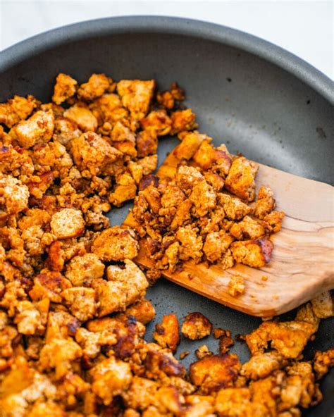 Tofu crumbles. Chop the tempeh in small pieces (about the size a cooked chickpea). Transfer the tofu and tempeh crumbles to a bowl. Add the tajin, adobo seasoning, chili powder, salt and ginger powder. Mix well ... 