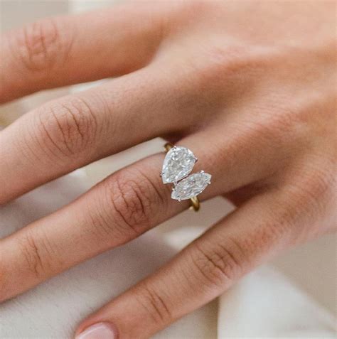 Toi et moi ring. Two shining diamonds in a toi et moi style wrap the finger in an aura of light for a look of chic sophistication (1/10 total carat weight). 