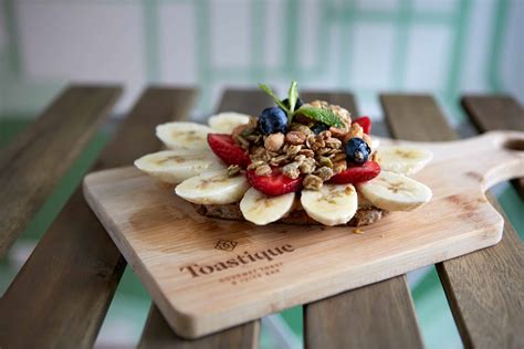 Tostique - PB B Bowl Blend of açai, banana, blueberry, peanut butter, almond milk topped with banana, blueberry, honey roasted peanut butter, chopped dates, peanuts, granola