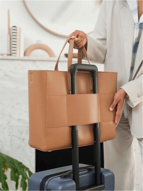 Tote with trolley sleeve. A sturdy and smart commuter. This tough yet polished laptop tote bag is thoughtfully designed, with features like internal popout bottle pockets and leakproof zippers. But its durable fabric shell ... 