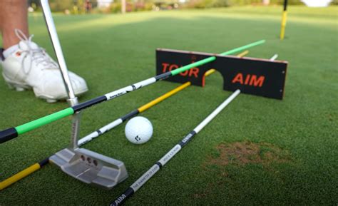 Tour aim golf. The Tour Aim Golf training aid helps improve and correct your golf swing plane and swing alignment. The Tour Aim is a solid wood block with holes drilled into it in specific spots. It allows you to place alignment sticks into certain holes so you can learn how to align your body, swing on plane, and even putt better. 