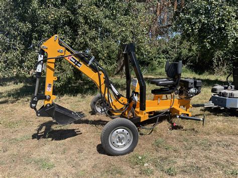 This portable NorTrac® Towable Trencher is powered by a high-performance 15 HP, Ducar 420cc engine. It's perfect for a wide variety of landscaping projects including trenching, planting trees, moving rocks and dirt, removing stumps and much more. It's also compatible with a ripper, loader, rock grabber and other extension components (sold ...