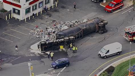 Tractor-trailer crash at Bell Circle in Revere spills scrap metal across lot, causes backups