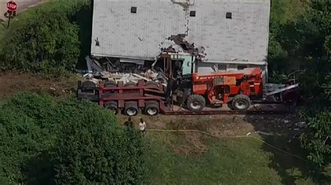 Tractor-trailer driver in critical condition after truck crashes through home in Bellingham