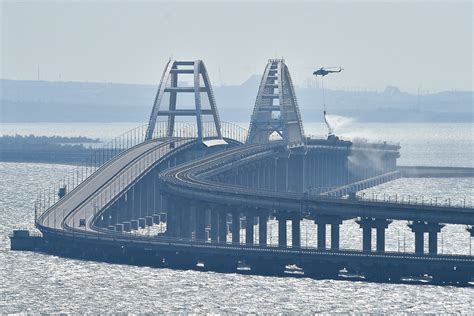 Traffic on key bridge from Crimea to Russia’s mainland halted amid reports of explosions and deaths