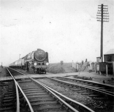 Train pulled by Britannia steam locomotive at Motts Lane Crossing