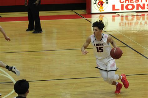 photo by: Chris Duderstadt Lawrence High junior Trey Quartlebaum drives to the basket in the first half of the Lions' 77-51 victory over Shawnee Mission Northwest on Tuesday at LHS.. 