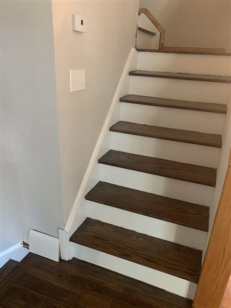 Trimming staircase. Place your drop cloth around the bottom of the staircase. With your fine-grit sandpaper (220-grit) and sanding sponge, sand the spindles, handrails, and any other wood surfaces to smooth them before painting. Vacuum up any sanding dust and wipe down your sanded surfaces with a damp cloth. Apply painter’s tape along your staircase and wall border. 