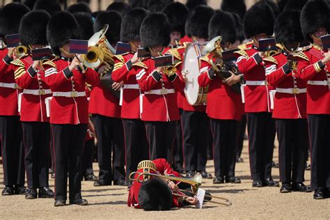 Troops feel the heat, and several faint, as Prince William reviews military parade
