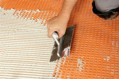 Trowel size for 12x24 tile on ditra. The substrate must be level and load-bearing. DITRA is installed in cementitious tile adhesive that is suitable for the substrate, using a notched trowel (recommended size: 3 x 3 mm or 4 x 4 mm). The anchoring fleece on the underside of DITRA is fully embedded and the fabric bonds with the adhesive. The curing time of the adhesive must be observed. 