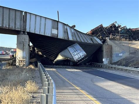 Truck driver killed when train derailment collapses Colorado bridge, spilling coal cars onto highway