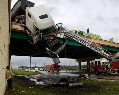 Truck driver rescued after cab is left dangling off Turnpike overpass in Palm Beach Gardens