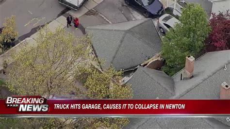 Truck hits garage in Newton, causes it to collapse