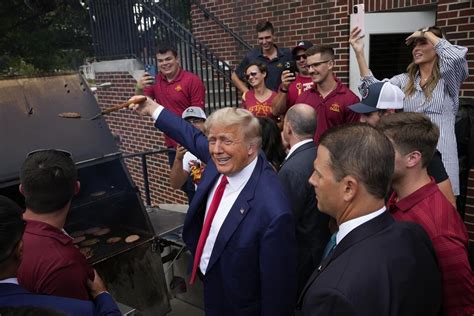 Trump stops at a fraternity house on his way to Iowa-Iowa State football game, outdrawing his rivals