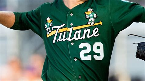 Former Tulane baseball coach Rick Jones, center, waves during ceremonies retiring his No. 10 jersey before Tulane played Wichita St. Friday, April 14, 2023, in New Orleans.. 