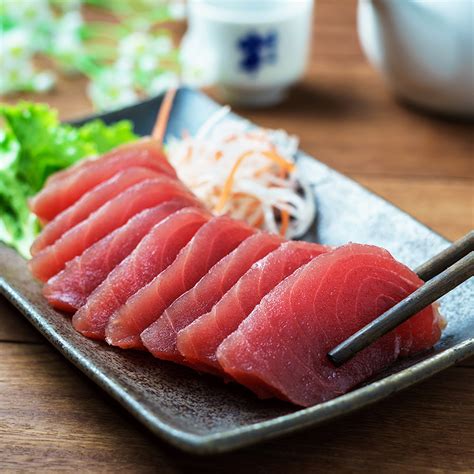 Tuna sashimi. Apr 9, 2015 · Instructions. Add ponzu, honey, soy sauce and ginger to a small bowl and whisk together. Set aside once ingredients are nicely mixed together. Assuming you don't have a sashimi knife, use a sharp chef's knife to slice your tuna into thin slices. 