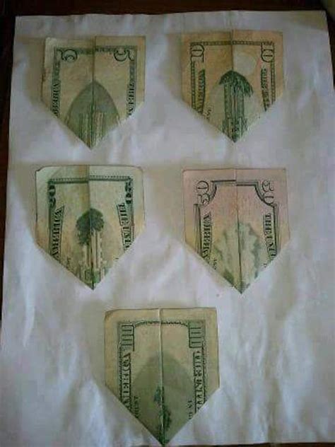 Twin towers dollar fold. The image of the White House on the back of the new US$20 bill, folded horizontally once to hide the face of Andrew Jackson and then both ends folded up as if … 