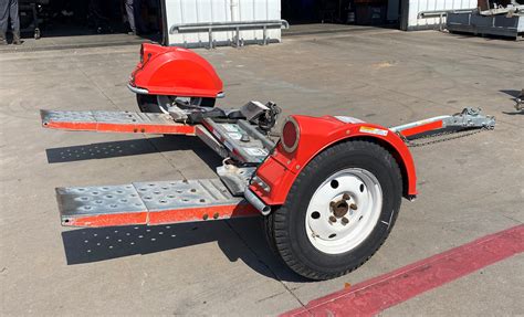 The tow dolly allows for a maximum car width of 76” from outside of tire to outside of tire on the front axle and can carry AWD, 4WD, or RWD vehicles of upto 3600 lbs or Front wheel drive vehicles of upto 3300 lbs. The Tow Dolly is not a trailer and cannot be backed up..