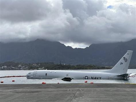 US Navy removes fuel from plane that overshot Hawaii runway and is now resting on a reef and sand