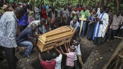 Ugandan border town buries victims of rebel massacre that left 42 dead, mostly students