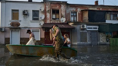 Ukrainians make desperate escape from floods after dam collapse as shelling echoes overhead