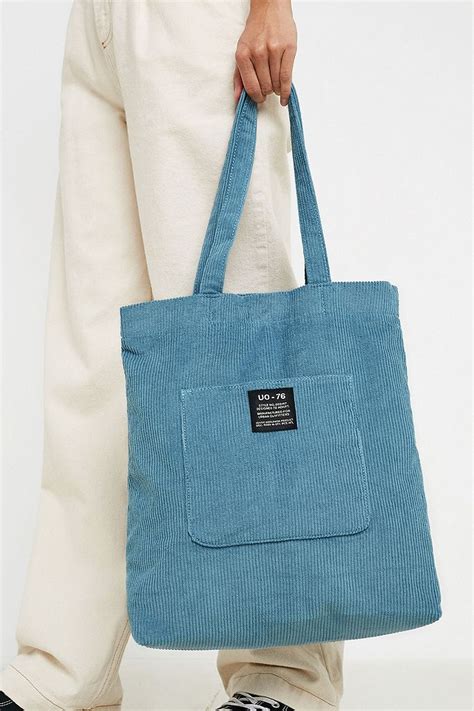 Y2K vibe with this washed-soft denim tote bag from BDG. Oversized silhouette with an open top and soft lining with a zip pocket. Find it only at Urban Outfitters. Features - Carryall tote bag from BDG - Shoulder strap . Content - 100% Cotton - Machine wash - Imported . Size - Dimensions: 12.99"l x 3.54"w x 8.26"h - Strap drop: 12.99" 