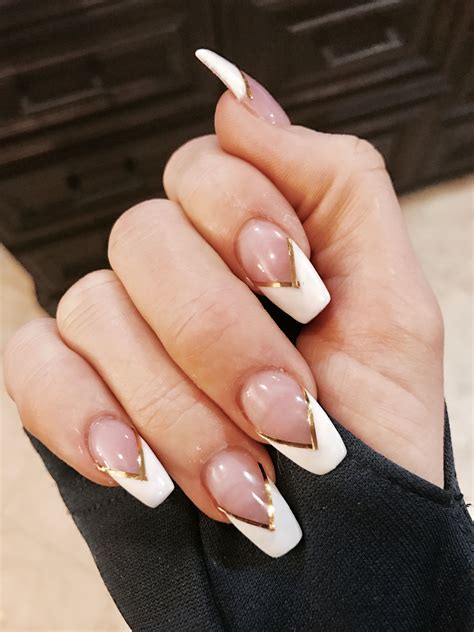 3. Short Coffin Shape French Nails. This next idea is a short coffin nails. All nails are nude base and three of with white V tips; and two of with light blue V tip and each one is adorned with silver stripe. You can create this look with rhinestones. Source：@marija_petrovic_mara. 4. V Shape French Tip Nails .
