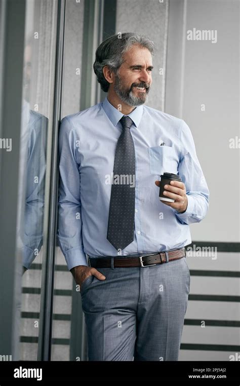 Vertical Portrait of a senior businessman moving through a busy ... - balustradellc