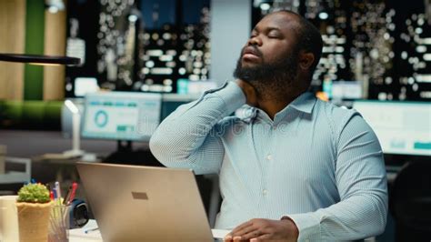 Vertical Video Male black employee does self massage to relieve neck ... - balustradellc