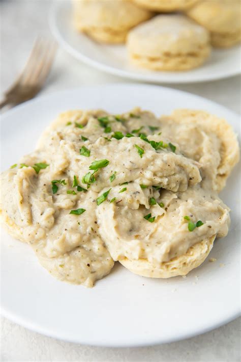 Vegan biscuits and gravy. Bake the biscuits for 20 – 25 minutes, until they are golden brown. Meanwhile, make the gravy. Heat a large skillet over medium heat and melt the butter. Add the minced vegan sausage and the onions, cook them until they start to brown. Then, add the flour, mix everything together and cook for about one minute. 