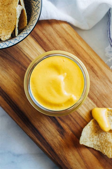 Vegan cheese sauce recipe. First, add the chickpeas to the blender cup, followed by the aquafaba, nutritional yeast, paprika, coconut aminos, mustard, apple cider vinegar, arrowroot starch, and garlic salt. Then seal the lid and start blending the ingredients for about 30 seconds. 