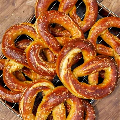Vegan pretzels. Preheat oven to 400 degrees F (200 C) and bring a pot filled with about 4 inches of water to a boil. Lay a clean towel on a tray, or counter top next to pot. Meanwhile, take each pretzel "snake" and bring the ends together to meet, then twist both sides together and place back on tray. 