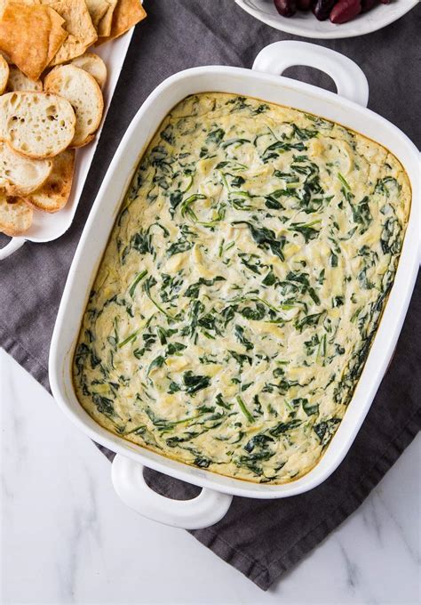 Vegan spinach and artichoke dip. Step-by-Step Process. Step 1: Pour olive oil into a skillet or sauté pan on medium heat. Add 3 cloves of minced garlic and cook until fragrant. Step 2: Stir in 10oz of chopped spinach, one handful at a time, cooking it down before adding the next handful. Step 3: Once the spinach has wilted, add the chopped artichokes. 