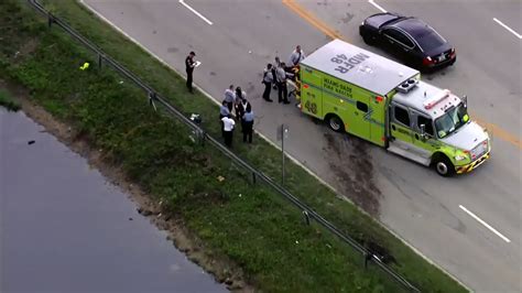 Vehicle goes into canal near Doral following 2-car crash; 1 hospitalized