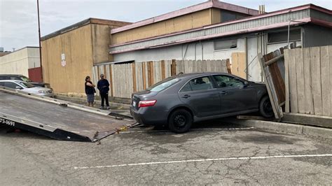 Vehicle loses control, crashes through fence in San Rafael: photos
