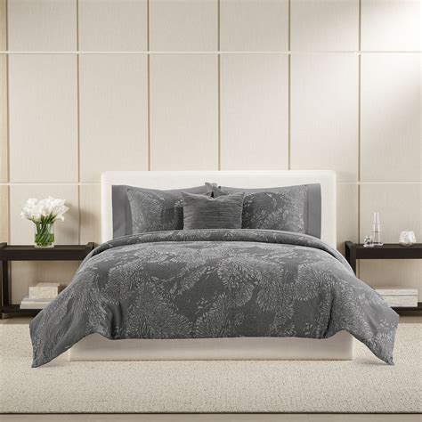 Bring modern textural style to your space with a vera wang Illusion comforter set. With its abstract stitching pattern on a solid gray ground, this collection will bring simple elegance to your home aesthetic. This set is certified standard 100 by Oeko-tex. The set includes one comforter and two shams and is machine washable for easy care.