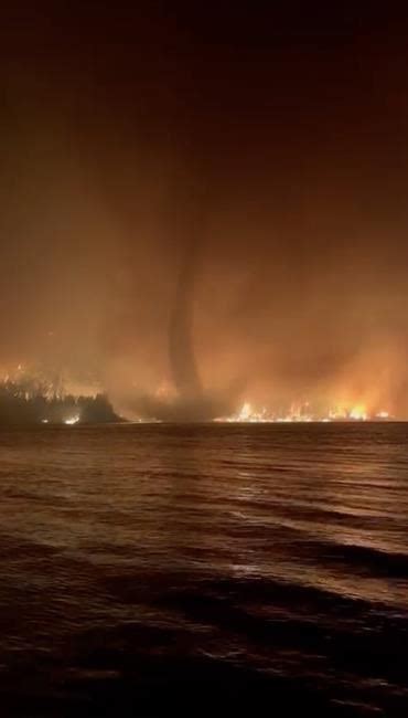 Video captures ‘incredibly rare’ B.C. wildfire tornado over lake