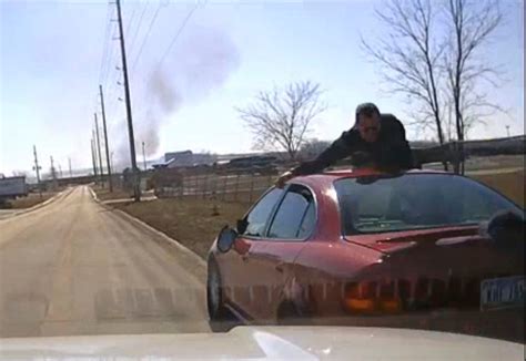 Video shows driver fleeing Iowa police with officer on hood, roof of car