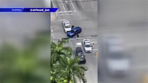 Video shows reckless driver nearly hitting Miami Police officer, striking cruiser in Brickell