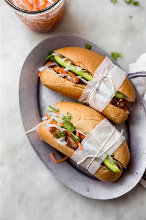 Vietnamese banh mi sandwiches. Put carrots, daikon and ingredients for the pickling into a bowl. Stir well and set aside for 15-20 minutes. In a bowl, add lime juice, fish sauce, 1/2 tsp salt, fresh black pepper, 2 tbsp oil, shallots and garlic. 