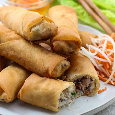 Vietnamese egg rolls. Remove mixture from heat and place on small cookie sheet. Place in refrigerator to cool for 30 minutes. Place warm water in a wide, shallow bowl, along with 2 tsp sugar. Microwave for 20-30 seconds if needed to dissolve sugar. Remove filling from the refrigerator to prepare rice paper egg rolls. Dip rice paper wrappers in warm water. 