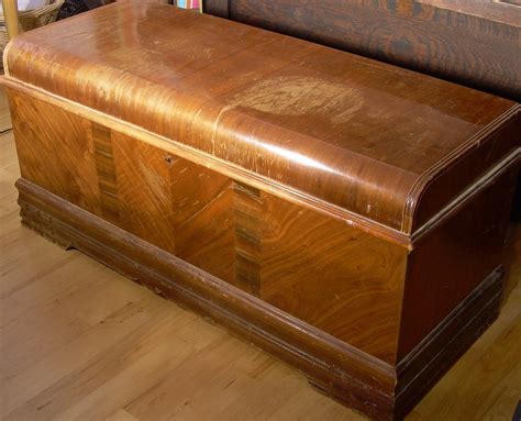 Vintage cedar chest. Classic vintage Lane waterfall design cedar chest. This chest has a great veneer selection. The front has a center section of burl veneer with diagonal chevrons on the ends, and contrasting bands on top and bottom edges. The sides are a sequenced cherry veneer. The lid features a sequenced vertical. 