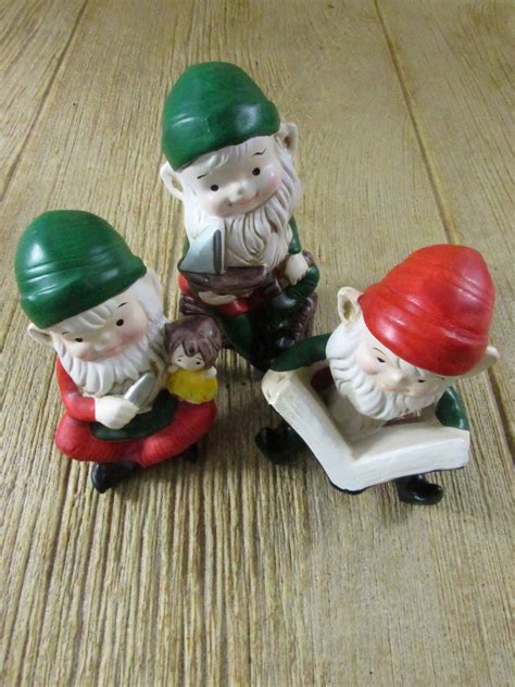This listing is for a pair of vintage ceramic Christmas figurines made in Japan. I'm not sure what they are. Maybe elves or Santa babies. They are in little red Santa suits. They have blonde hair and blue eyes. I believe the eyes could be glass. Very unique. Marked Japan on the bottom. No chips or