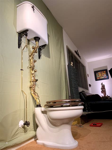 Vintage toilet. Antique toilet with wall mount tank and pull chain flush. Not for sale, prop rental only. 