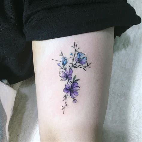 Violet and primrose tattoos. This beautiful flower tattoo for women features a very magical aesthetic that is reminiscent of the rose in Beauty and the Beast. The tattoo’s elegant design also gives the flower a very jewelry-like appearance, while the pink and violet color gives it a very romantic feel. #tattoofriday #tattoos #tattooart #tattoodesign #tattooidea 