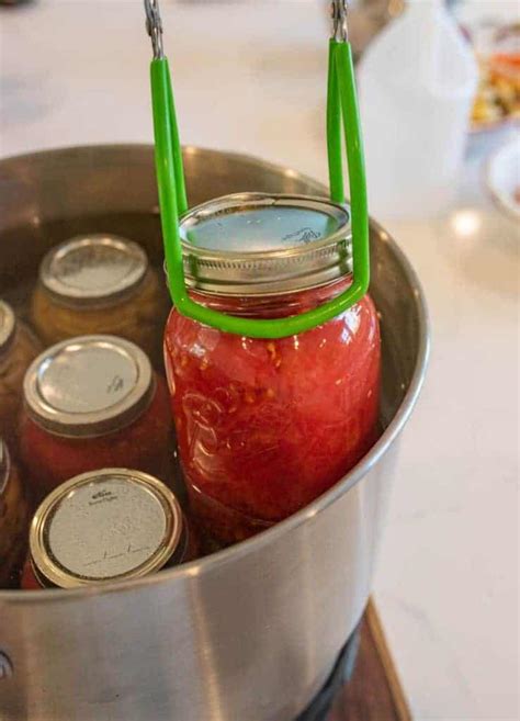 Water bath canning tomatoes. Mar 10, 2022 · Put the jar back into the hot water within the pressure canner, move on to the next jar and finish them all. Resist the temptation to tighten the rings down too hard when canning tomatoes, finger tight is sufficient. Follow the instructions for your pressure canner. Process quarts and pints for 10 minutes with 10 PSI. 