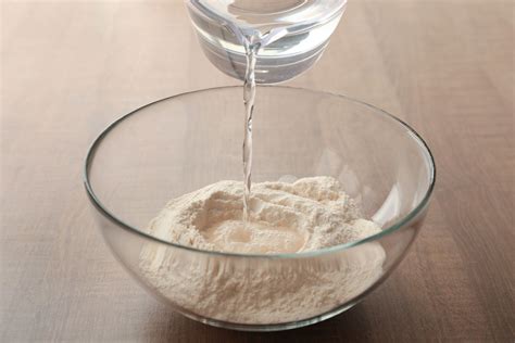 Water flour. When flour is mixed with water, the proteins in the flour form gluten. Gluten is what gives dough its elasticity and strength and is essential for making bread rise and providing structure to baked goods. The hydration of flour is crucial for activating enzymes and developing the gluten network. This is why recipes often call for … 