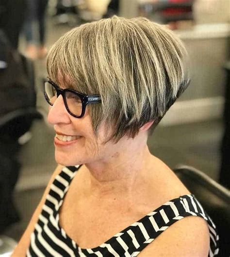 Wedge haircuts for older women. 1: Layered Hair Back View. Embrace elegance with an ash blonde, layered hairstyle tailored for women over 50. The back view reveals a cascade of layers that add depth and volume, creating a youthful look. The ash blonde hue offers a sophisticated touch, making this the perfect hairstyle for those seeking a blend of grace and style. 