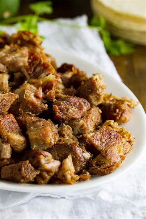 What are carnitas. Cut pork into 2-inchmcubes, add to a large pot with the juice, water, and salt. Bring to a boil and then simmer uncovered on low for 2 hours. Do not touch the meat. After 2 hours, turn heat up to medium high, and continue to cook until all the liquid has evaporated and the pork fat has rendered (about 45 minutes). 